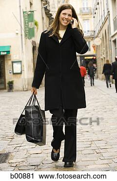 Stock Photography - portrait of a 
young woman walking 
with shopping 
bags. fotosearch 
- search stock 
photos, pictures, 
images, and photo 
clipart
