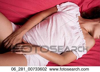 Stock Photo - above view mid 
section woman 
lying on a bed 
with her head 
turned and. fotosearch 
- search stock 
photos, pictures, 
images, and photo 
clipart
