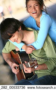 Stock Photo - front view waist 
woman looking 
at camera embracing 
a man playing. 
fotosearch - search 
stock photos, 
pictures, images, 
and photo clipart
