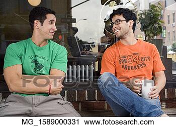 Stock Photography - two young men 
hang talk infront 
of a shop while 
enjoying a drink. 
fotosearch - search 
stock photos, 
pictures, images, 
and photo clipart