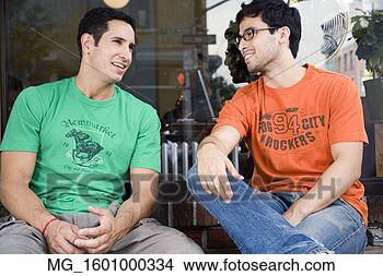 Stock Photo - two young men 
hang talk infront 
of a shop while 
enjoying a drink. 
fotosearch - search 
stock photos, 
pictures, images, 
and photo clipart