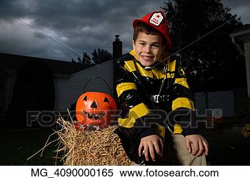 Stock Image - a young boy out 
on halloween  
he is wearing 
a fireman costume. 
fotosearch - search 
stock photos, 
pictures, images, 
and photo clipart