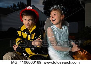 Stock Photograph - a young girl & 
boy out on halloween 
 he is wearing 
a fireman costume. 
fotosearch - search 
stock photos, 
pictures, images, 
and photo clipart