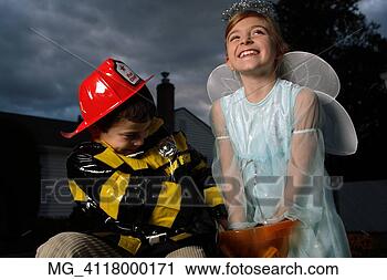 Stock Photography - a young girl & 
boy out on halloween 
 he is wearing 
a fireman costume. 
fotosearch - search 
stock photos, 
pictures, images, 
and photo clipart