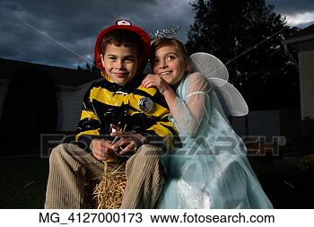 Stock Photo - a young girl & 
boy out on halloween 
 he is wearing 
a fireman costume. 
fotosearch - search 
stock photos, 
pictures, images, 
and photo clipart