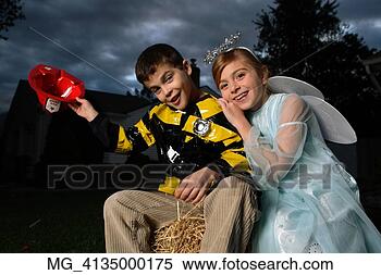 Stock Image - a young girl & 
boy out on halloween 
 he is wearing 
a fireman costume. 
fotosearch - search 
stock photos, 
pictures, images, 
and photo clipart