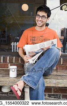Stock Photo - a young man in 
glasses,  orange 
shirt and blue 
jeans,  and flip 
flops. fotosearch 
- search stock 
photos, pictures, 
images, and photo 
clipart