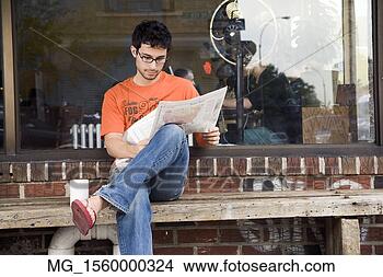 Stock Photo - a young man in 
glasses,  orange 
shirt and blue 
jeans,  and flip 
flops. fotosearch 
- search stock 
photos, pictures, 
images, and photo 
clipart