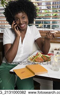 Stock Photo - a young woman 
her 20's wearing 
in a white short 
sleeve top and 
green. fotosearch 
- search stock 
photos, pictures, 
images, and photo 
clipart