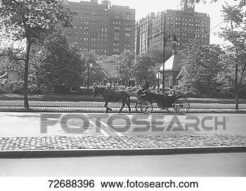 Stock Photo - horse carriage 
riding on street, 
(b&w). fotosearch 
- search stock 
photos, pictures, 
images, and photo 
clipart