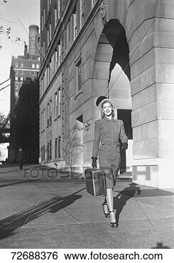 Stock Photo - woman carrying 
suitcase walking 
on sidewalk, (b&w). 
fotosearch - search 
stock photos, 
pictures, images, 
and photo clipart