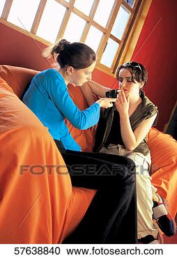 Stock Photography - side profile of 
a girl lighting 
a cigarette from 
a friend. fotosearch 
- search stock 
photos, pictures, 
images, and photo 
clipart