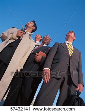 Stock Photography - low angle shot 
of businessmen 
standing together 
outdoor. fotosearch 
- search stock 
photos, pictures, 
images, and photo 
clipart