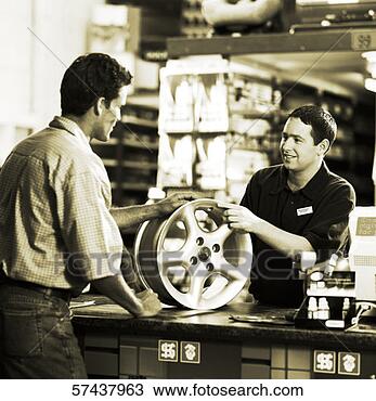 Stock Photo - black and white 
portrait of a 
young sales man 
handing a hub 
wheel of. fotosearch 
- search stock 
photos, pictures, 
images, and photo 
clipart