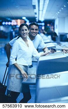Stock Photography - tungsten shot 
of a young couple 
standing at a 
counter. fotosearch 
- search stock 
photos, pictures, 
images, and photo 
clipart