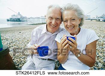 Stock Photo - front view of 
a mature couple 
having coffee 
on the beach. 
fotosearch - search 
stock photos, 
pictures, images, 
and photo clipart