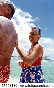 Stock Photo - portrait of an 
elderly woman 
applying sun block 
lotion on her. 
fotosearch - search 
stock photos, 
pictures, images, 
and photo clipart