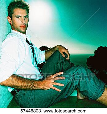 Stock Photo - side profile close-up 
of a man sitting 
with his pants 
rolled up. fotosearch 
- search stock 
photos, pictures, 
images, and photo 
clipart