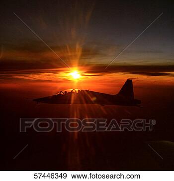 Stock Photograph - side profile of 
a fighter jet 
flying across 
the sun. fotosearch 
- search stock 
photos, pictures, 
images, and photo 
clipart