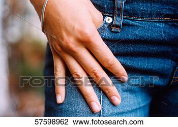 Stock Photo - close-up of a 
hand with the 
thumb in the jeans 
pocket. fotosearch 
- search stock 
photos, pictures, 
images, and photo 
clipart