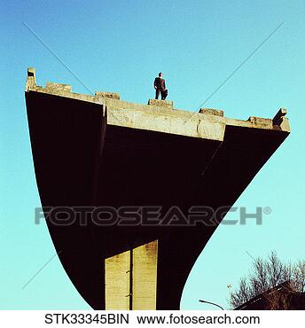 Stock Photo - low angle view 
of a businessman 
standing atop 
an incomplete 
bridge. fotosearch 
- search stock 
photos, pictures, 
images, and photo 
clipart