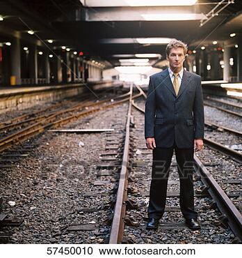 Stock Photography - portrait of a 
businessman standing 
on underground 
railroad tracks. 
fotosearch - search 
stock photos, 
pictures, images, 
and photo clipart