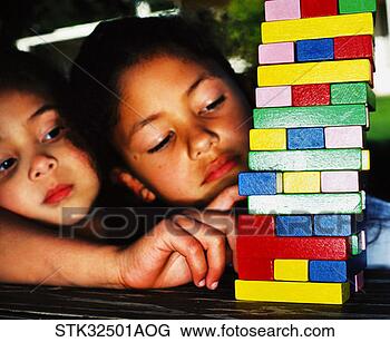 Stock Photo - close-up of two 
girls (6-8) making 
a stack of colored 
blocks on a. fotosearch 
- search stock 
photos, pictures, 
images, and photo 
clipart