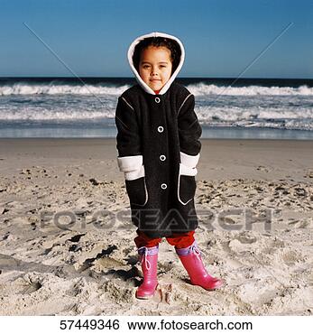 Stock Photo - portrait of a 
girl (6-8) is 
a jacket and boots 
standing on the 
beach. fotosearch 
- search stock 
photos, pictures, 
images, and photo 
clipart