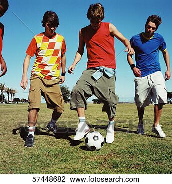 Stock Photo - a group of teenage 
boys playing football. 
fotosearch - search 
stock photos, 
pictures, images, 
and photo clipart