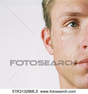 Stock Photo - close-up of the 
side of a man's 
face with a tear 
coming out of 
his eye. fotosearch 
- search stock 
photos, pictures, 
images, and photo 
clipart