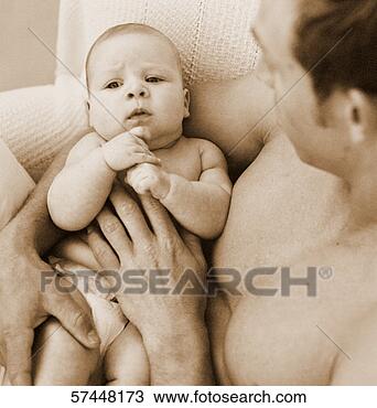 Stock Photo - sepia toned high 
angle close-up 
of a baby in a 
man's lap. fotosearch 
- search stock 
photos, pictures, 
images, and photo 
clipart