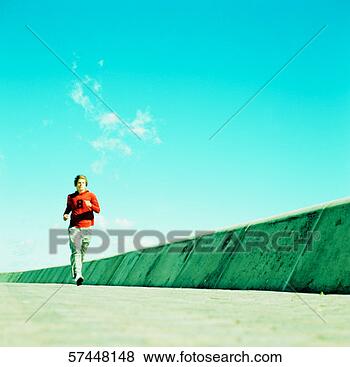 Stock Photo - view from a distance 
of a man jogging. 
fotosearch - search 
stock photos, 
pictures, images, 
and photo clipart