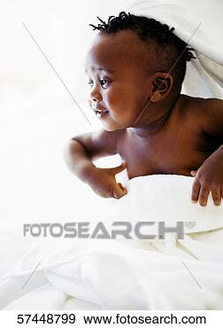 Stock Photograph - baby (12-18 months) 
wrapped in a white 
towel smiling. 
fotosearch - search 
stock photos, 
pictures, images, 
and photo clipart