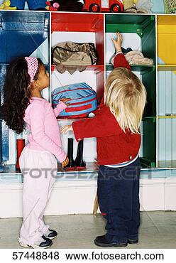 Stock Photo - two young girls 
(2-4) standing 
next to storage 
shelves reaching 
up. fotosearch 
- search stock 
photos, pictures, 
images, and photo 
clipart