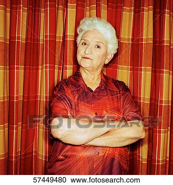 Stock Photography - portrait of an 
elderly woman 
standing with 
her arms folded. 
fotosearch - search 
stock photos, 
pictures, images, 
and photo clipart
