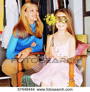 Stock Photo - portrait of a 
young girl sitting 
in a costume next 
to her mother. 
fotosearch - search 
stock photos, 
pictures, images, 
and photo clipart