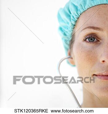 Stock Photo - a female doctor 
wearing protective 
headgear and using 
a stethoscope. 
fotosearch - search 
stock photos, 
pictures, images, 
and photo clipart