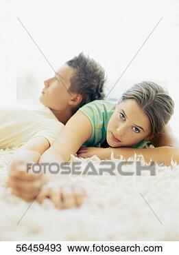 Stock Photo - teenage couple 
lying together 
on a rug. fotosearch 
- search stock 
photos, pictures, 
images, and photo 
clipart