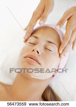 Stock Photograph - close-up of a 
young woman getting 
a face massage 
from a massage. 
fotosearch - search 
stock photos, 
pictures, images, 
and photo clipart