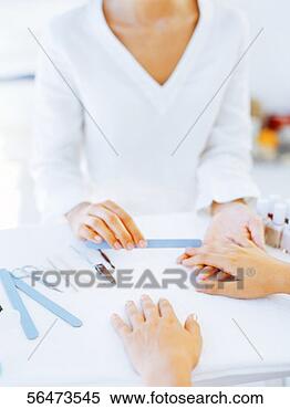 Stock Image - woman having her 
nail filed. fotosearch 
- search stock 
photos, pictures, 
images, and photo 
clipart
