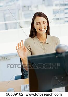 Stock Photo - businesswoman 
sitting in front 
of a video conference 
camera in an. 
fotosearch - search 
stock photos, 
pictures, images, 
and photo clipart