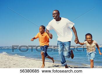 Stock Image - father and his 
children running 
on the beach. 
fotosearch - search 
stock photos, 
pictures, images, 
and photo clipart