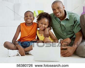 Stock Photo - portrait of a 
father and his 
children in front 
of a laptop. fotosearch 
- search stock 
photos, pictures, 
images, and photo 
clipart