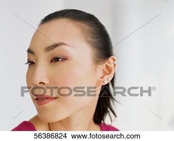 Stock Photo - close-up of a 
young woman looking 
sideways. fotosearch 
- search stock 
photos, pictures, 
images, and photo 
clipart