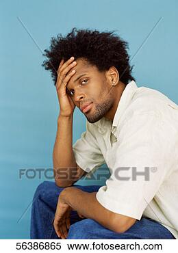 Stock Image - portrait of a 
young man with 
his hand on his 
head. fotosearch 
- search stock 
photos, pictures, 
images, and photo 
clipart