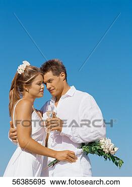 Stock Image - low angle view 
of a newlywed 
couple standing 
face to face. 
fotosearch - search 
stock photos, 
pictures, images, 
and photo clipart