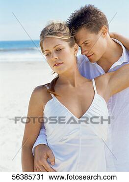 Stock Photography - newlywed couple 
standing on the 
beach. fotosearch 
- search stock 
photos, pictures, 
images, and photo 
clipart