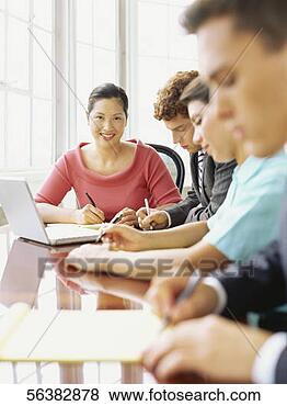 Stock Photo - four business 
executives sitting 
around a table 
in an office. 
fotosearch - search 
stock photos, 
pictures, images, 
and photo clipart