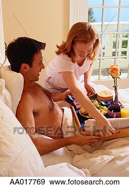 Stock Photograph - woman serving 
a man breakfast 
in bed. fotosearch 
- search stock 
photos, pictures, 
images, and photo 
clipart