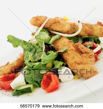 Stock Photograph - close-up of fried 
fish served with 
onion rings and 
lettuce. fotosearch 
- search stock 
photos, pictures, 
images, and photo 
clipart